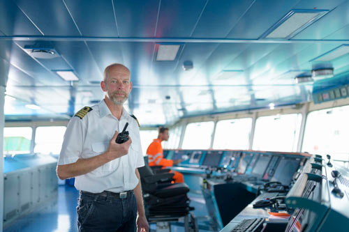 A captain stands on the bridge