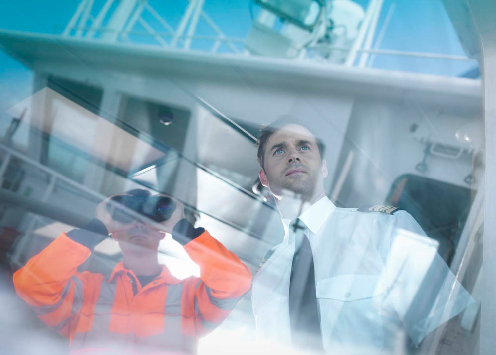 A naval officer looks out the window